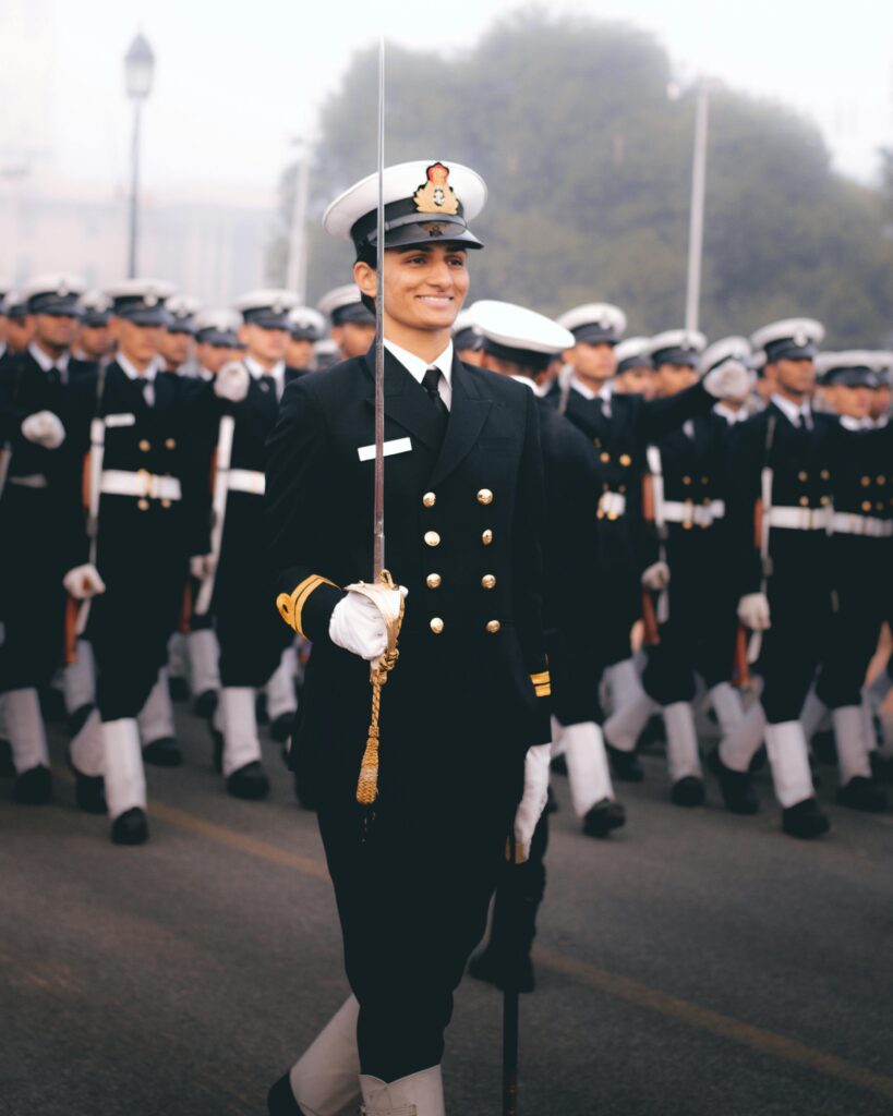 Indian naval personnel in ceremonial uniforms march with precision during Republic Day parade.